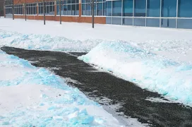 Snow cleared from the path outside a commercial building.