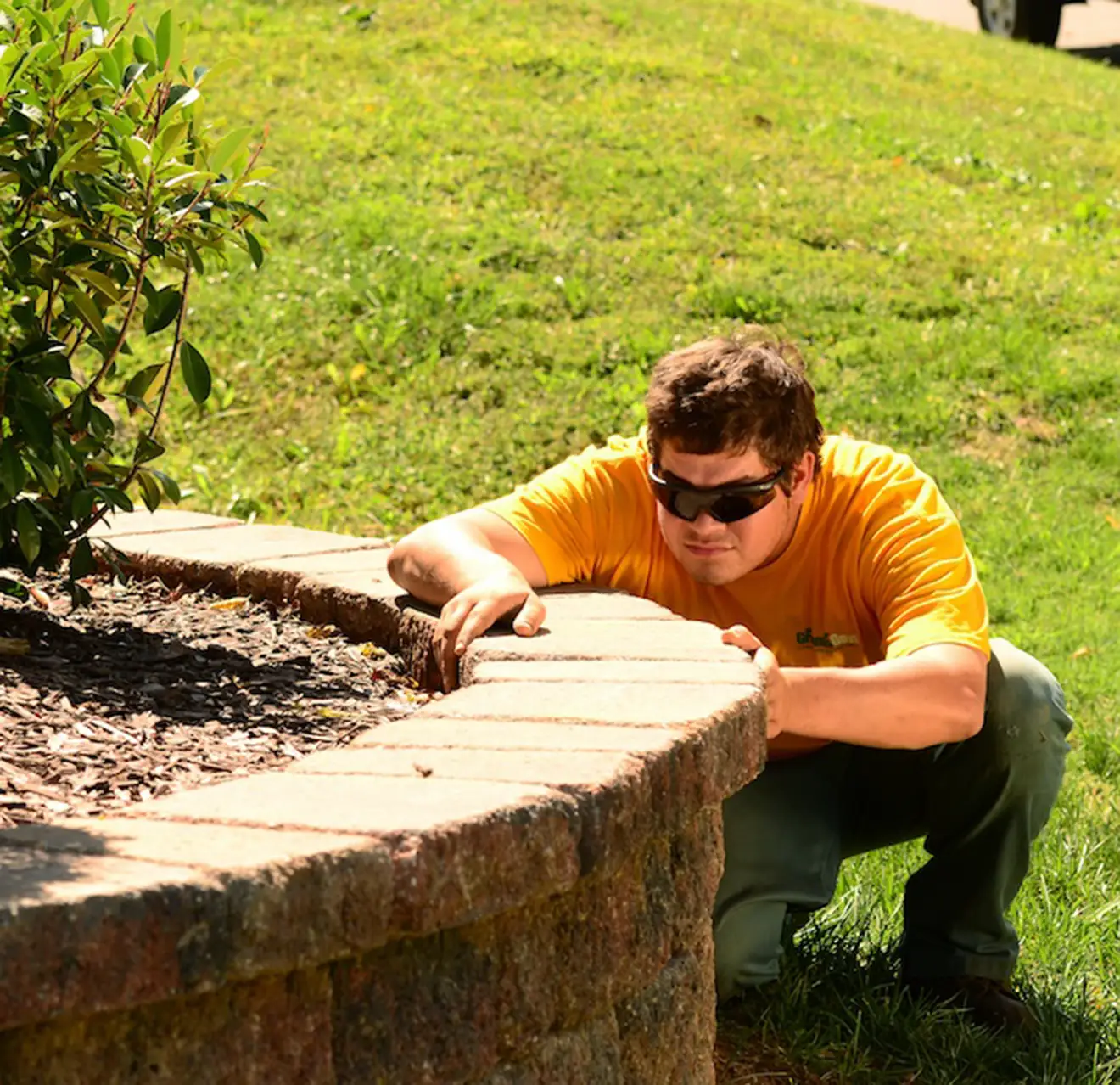 GUY technician installing a paver wall.