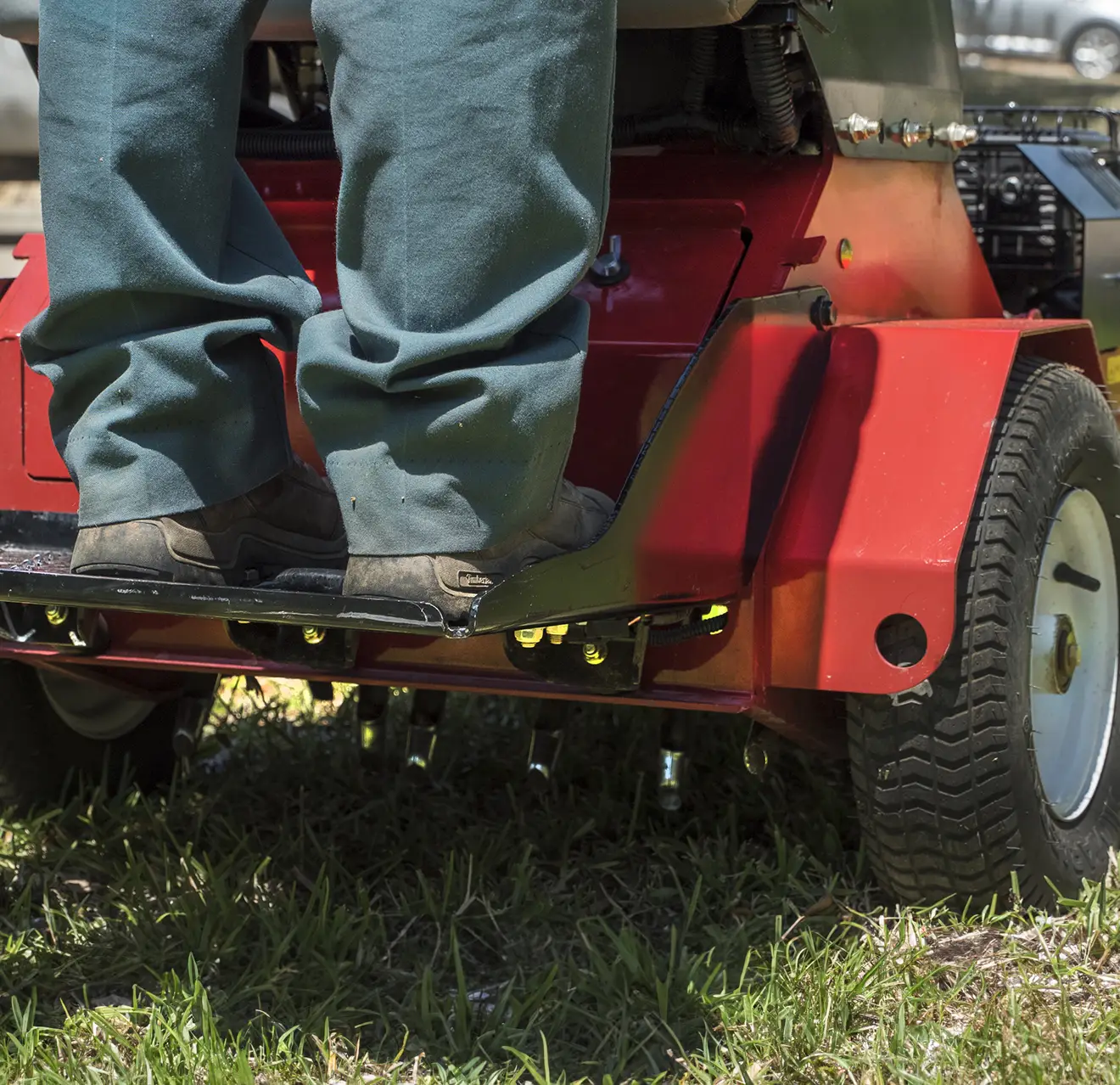 GUY technician mowing lawn.