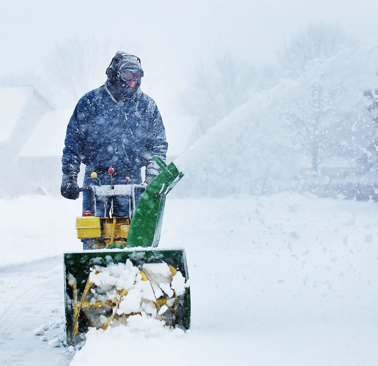 GUY technician blowing snow.