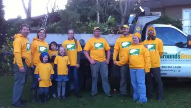 Employees of The Grounds Guys of Abbotsford standing in front of a truck.