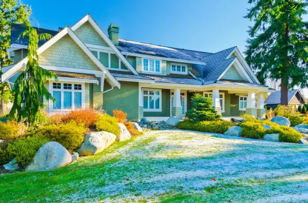 Residential front yard with light snow covering