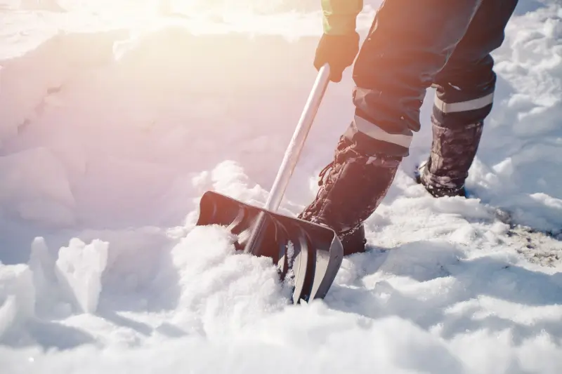 Person removing snow with a shovel