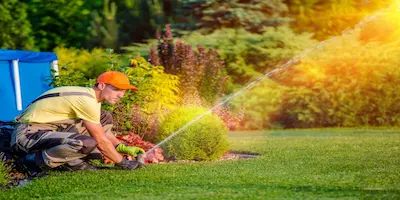 man setting up sprinkler system